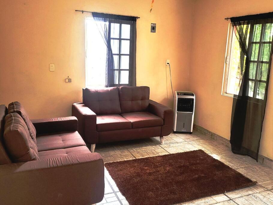 a living room with a couch and a chair at Hermosa Casa en Cuatro ciénegas in Cuatrociénegas de Carranza