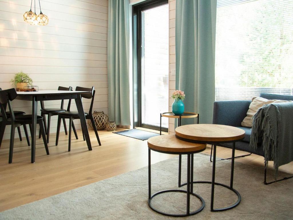 a living room with a table and chairs and a couch at Holiday Home Kasnäs marina c 22 by Interhome in Kasnäs