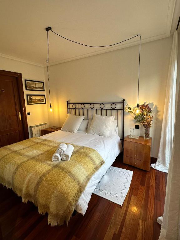 a bedroom with a bed with two teddy bears on it at Paseo Tenorio, remanso de paz con PISCINA in Ezcaray