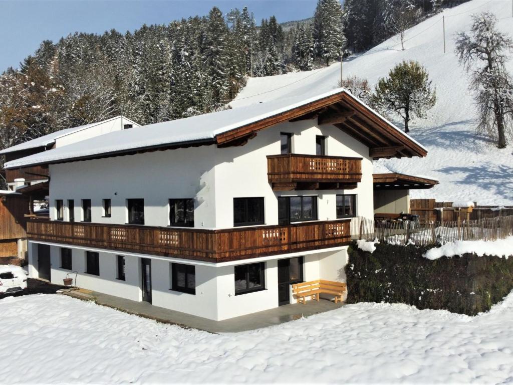 a house in the snow with snow at Apartment Mäuerl by Interhome in Hart im Zillertal