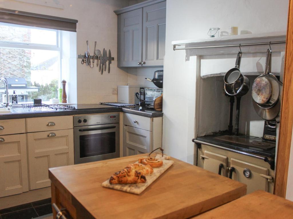 a kitchen with a table with chickens on it at Le Grand Bleu, 1 Court Cottages in Kingsbridge
