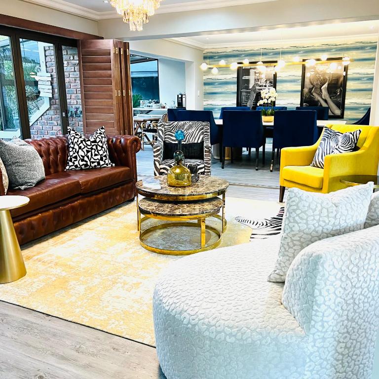 a living room with couches and a coffee table at Blue View B&B in East London