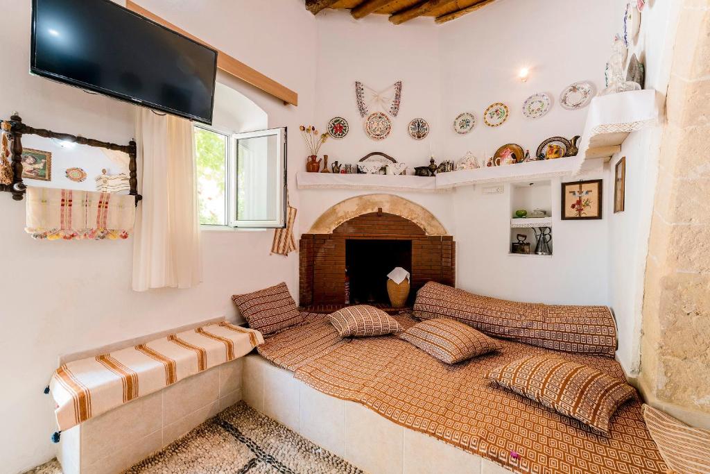 A bed or beds in a room at Kamariko Traditional House