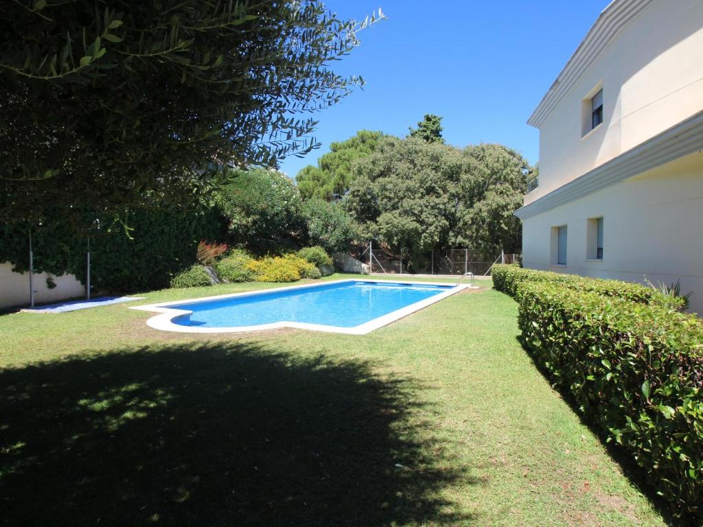 a swimming pool in a yard next to a house at Apartamento Llançà, 2 dormitorios, 5 personas - ES-228-74 in Llança