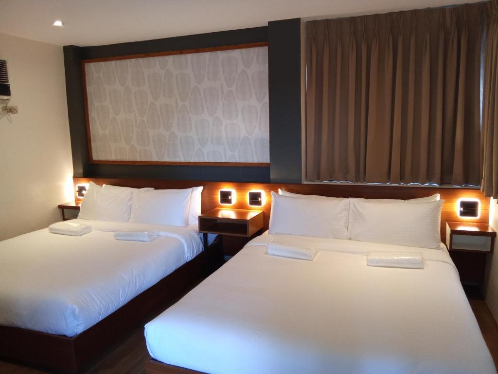 Postel nebo postele na pokoji v ubytování Jovinaj Travellers Inn