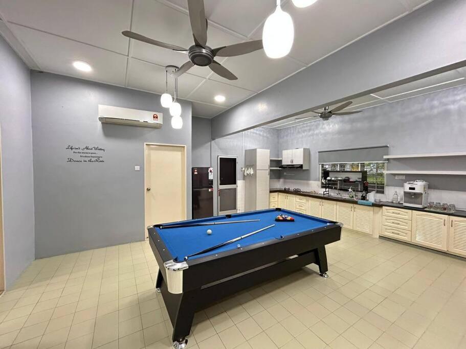 a pool table in the middle of a kitchen at Blossom seremban spacious comfy in Seremban