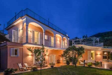 a large house with a lawn in front of it at Campanella Villas Gardens Pool Superview in Termini