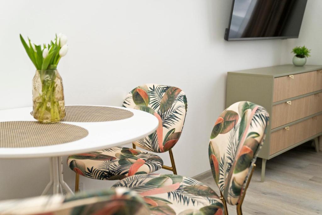 a room with a table and chairs and a table at Central Station Apartment No8 in Kaunas