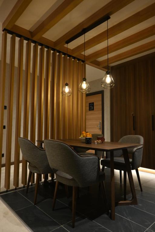 a dining room with a wooden table and chairs at KOPAONIK WOODSIDE 58,70 m2 FREE Parking in Kopaonik