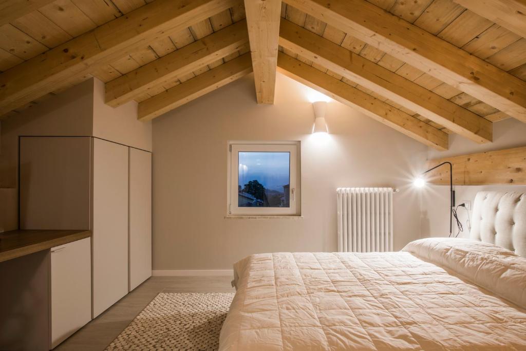 een slaapkamer met een groot bed en houten plafonds bij Le Tre Sorelle in Il Guasto