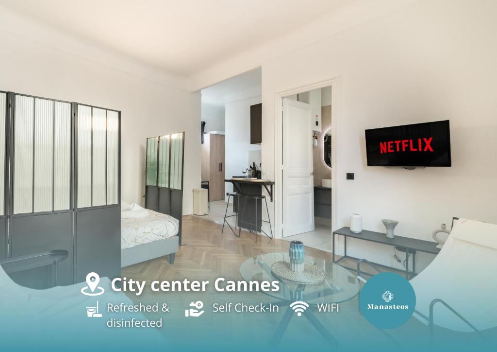 a living room with a tv on a wall at Hypercentre - Palais - Croisette - Beach in Cannes