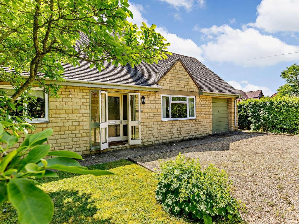 a yellow brick house with a driveway at 2 bed in Moreton in Marsh 83379 in Blockley