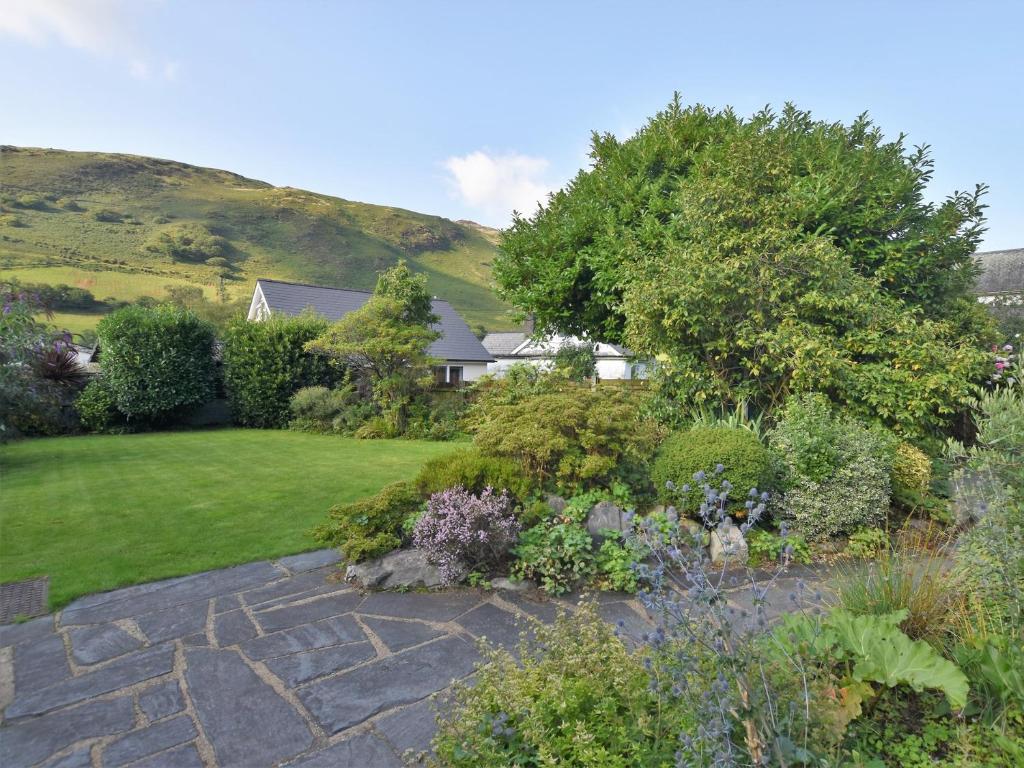 a garden with a stone path and plants at 2 bed in Tywyn 83956 in Abergynolwyn