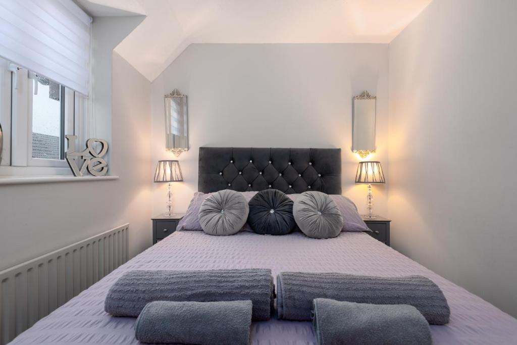 a bedroom with a large bed with two pillows at WORCESTER Fabulous Cherry Tree Mews self check in dogs welcome by prior arrangement , 2 double bedrooms ,super fast Wi-Fi, with free off road parking for 2 vehicles near Royal Hospital and woodland walks in Worcester