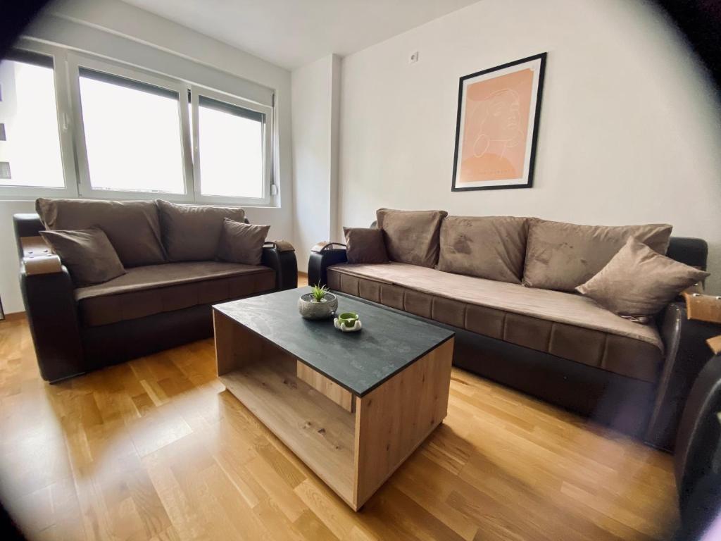 a living room with a couch and a coffee table at BK2 APARTMAN in Kragujevac