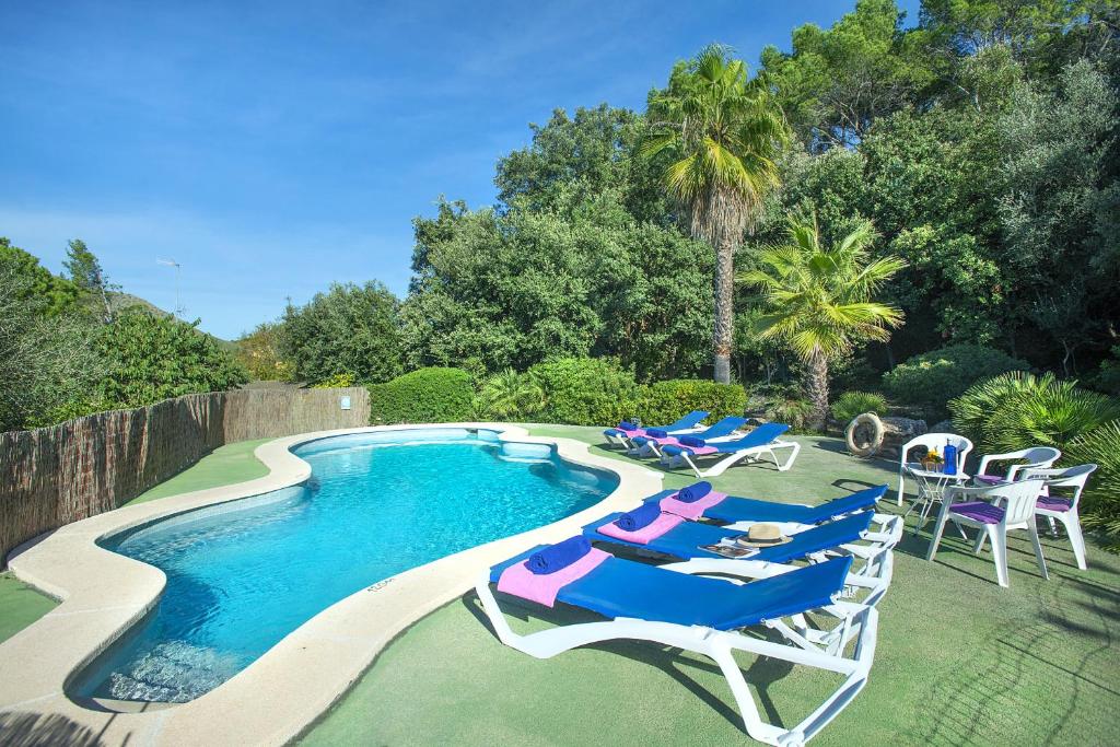 a pool with chaise lounge chairs and a swimming pool at Owl Booking Villa Moragues - Surrounded By Nature in El Port