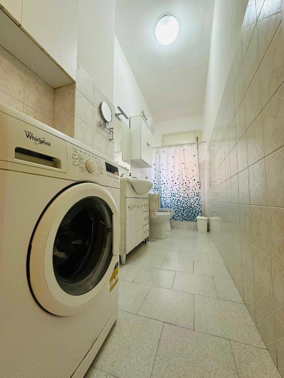 a washing machine in a bathroom with a toilet at Ferdirisa Vesuvio Home&Garden in San Giorgio a Cremano