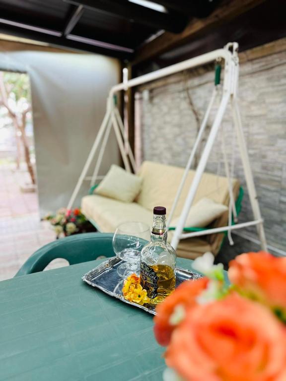 a bottle of alcohol sitting on a table with a tray at Ferdirisa Vesuvio Home&Garden in San Giorgio a Cremano