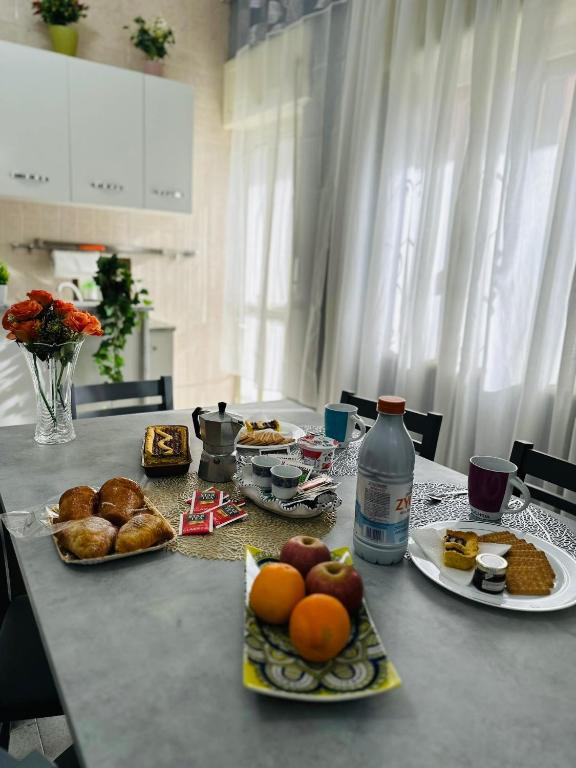 a table with plates of food and drinks on it at Ferdirisa Vesuvio Home&Garden in San Giorgio a Cremano