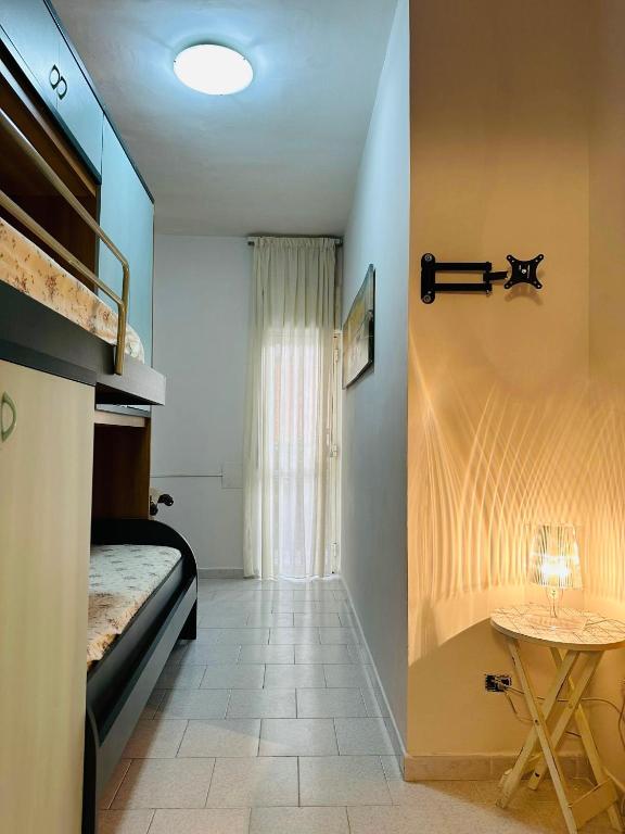 a small room with a bed and a table at Ferdirisa Vesuvio Home&Garden in San Giorgio a Cremano