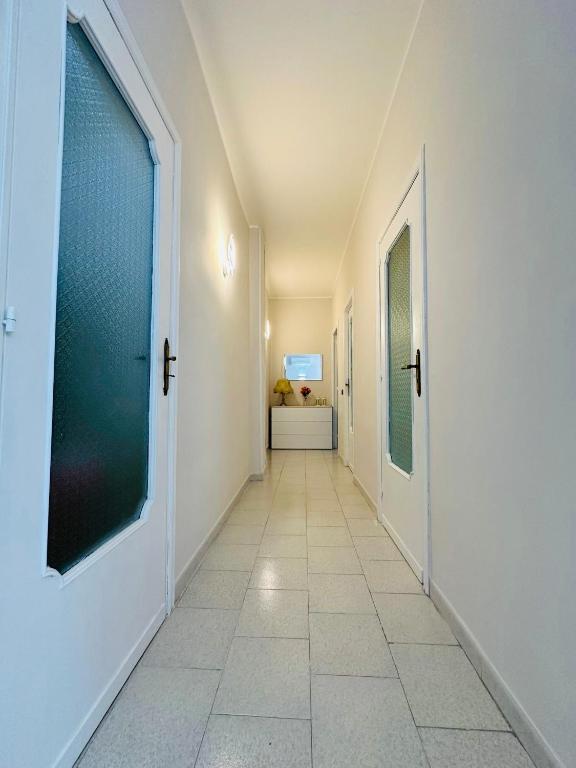 a hallway with a door and a tile floor at Ferdirisa Vesuvio Home&Garden in San Giorgio a Cremano