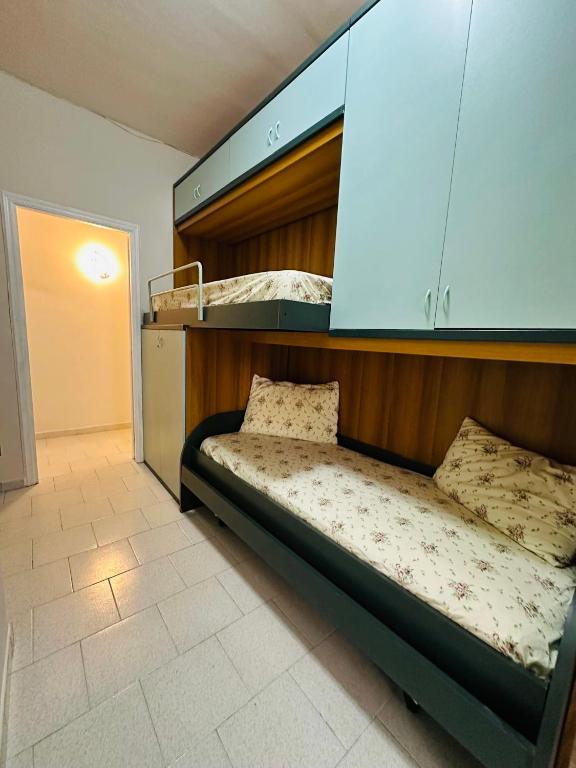 a bed in a room with a bunk bed at Ferdirisa Vesuvio Home&Garden in San Giorgio a Cremano