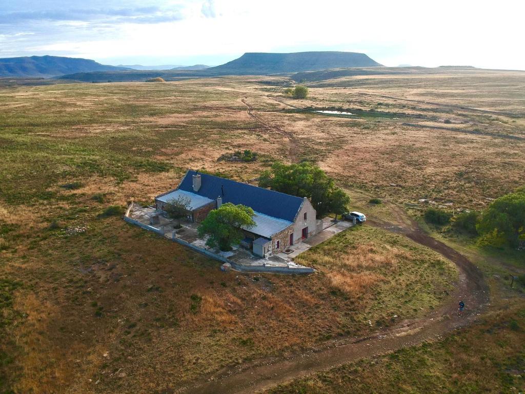 an aerial view of a house in the middle of a field at Sneeuberg Nature Reserve in Nieu-Bethesda