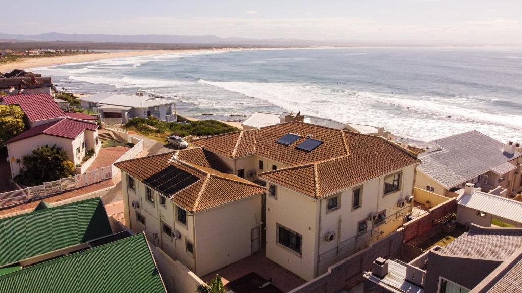 an aerial view of the beach and houses at Spekboom Beach Apartments in Jeffreys Bay