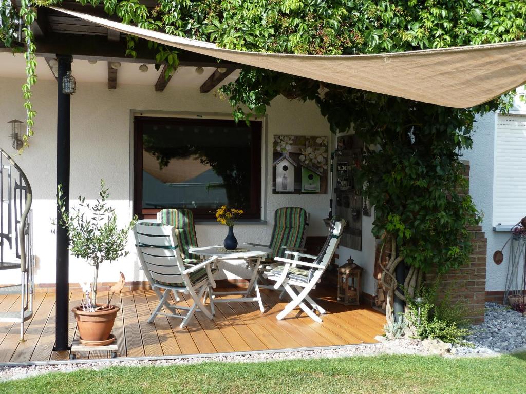 a patio with a table and chairs on a deck at Casa Graf in Bad Emstal