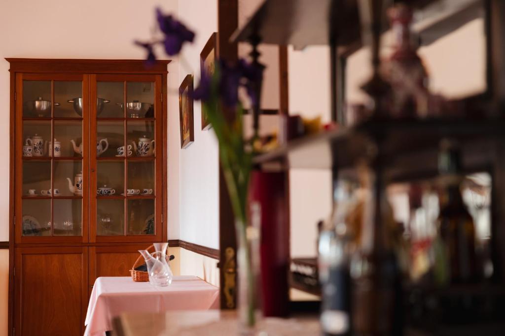 a room with a table and a cabinet with china at Solar de Lalém in Maia