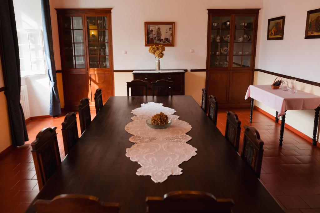 a dining room with a table with a white napkin on it at Solar de Lalém in Maia