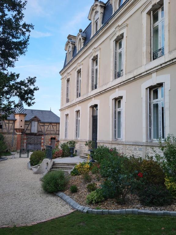 a large building with a garden in front of it at LES 5 ESCALES in Parthenay
