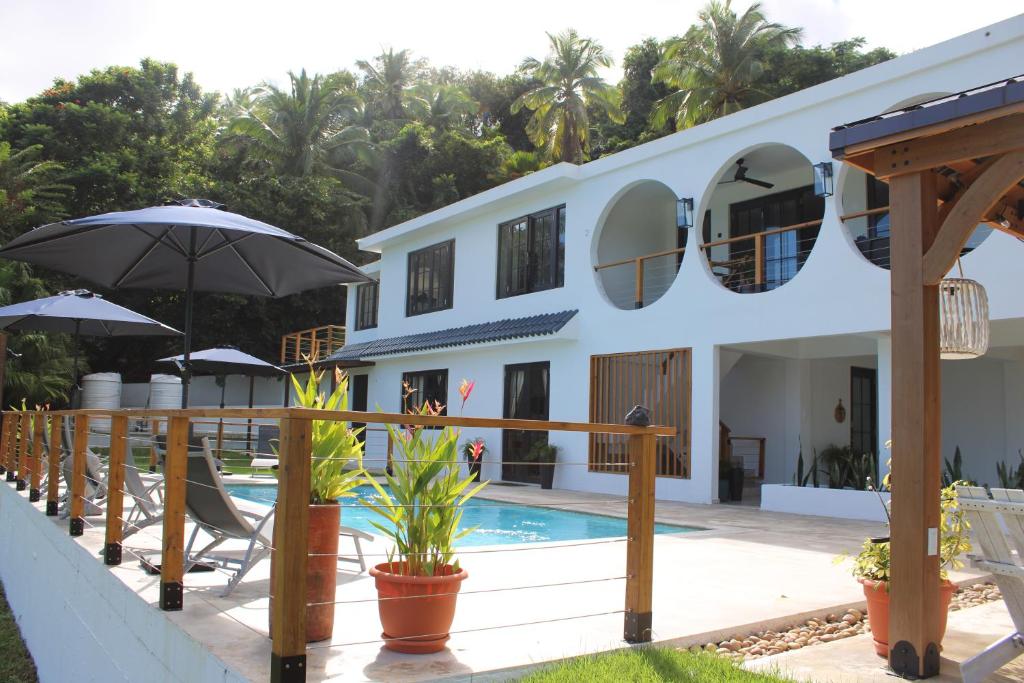 a villa with a swimming pool and a resort at The Serene House Bed & Breakfast in Luquillo