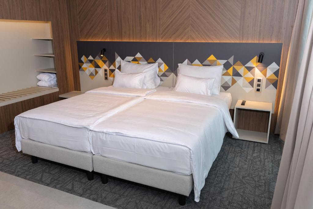 Ένα ή περισσότερα κρεβάτια σε δωμάτιο στο Austria Trend Hotel Ljubljana