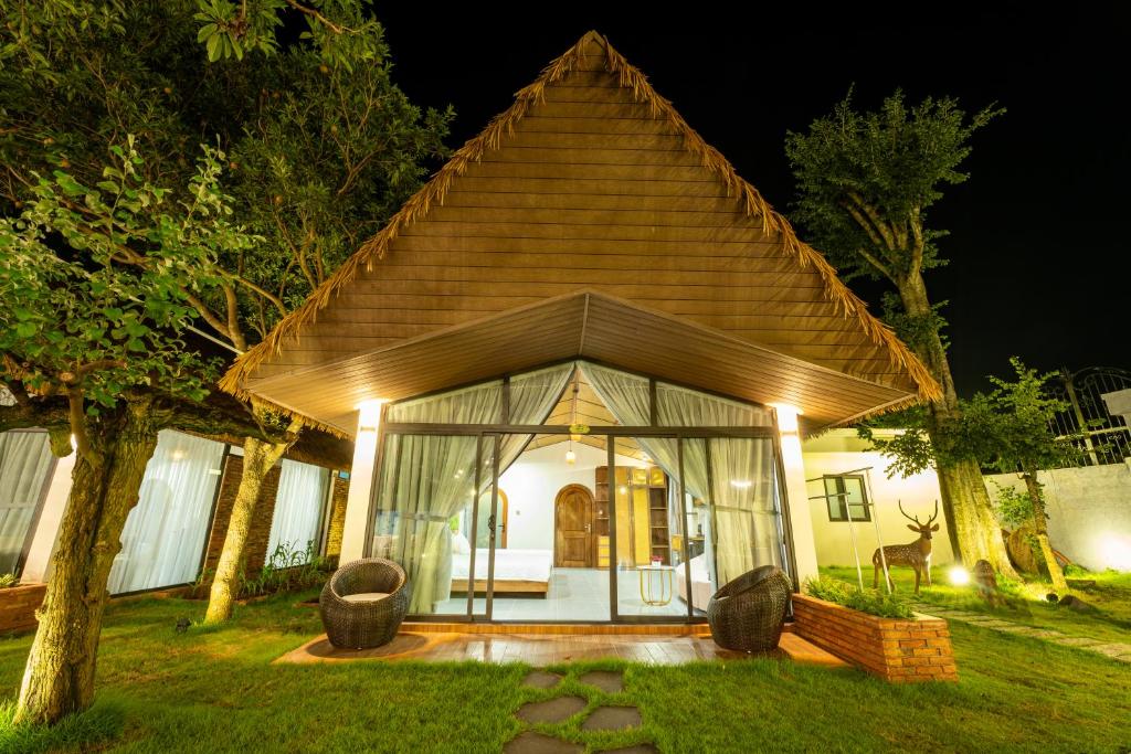 a small house with a pitched roof with lights at Apple House & Coffee in Ba Ria
