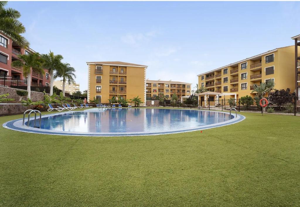 a large swimming pool in the middle of a park at LOVE ISLAND 77 in Palm-mar