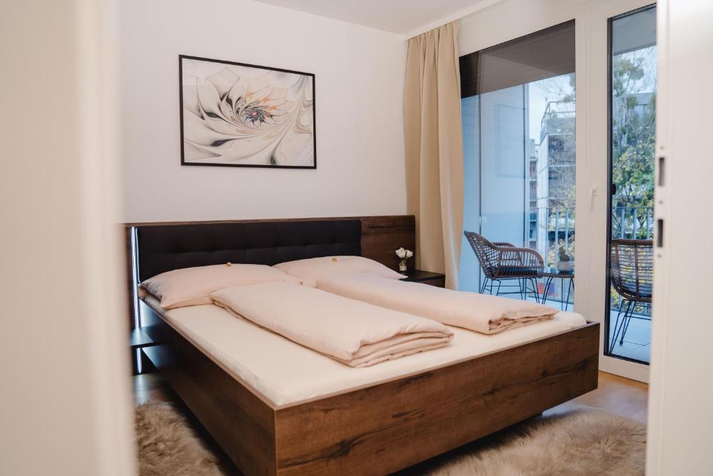 a bedroom with a bed and a balcony at 10 minutes to the center, 2 minutes to the metro in Vienna