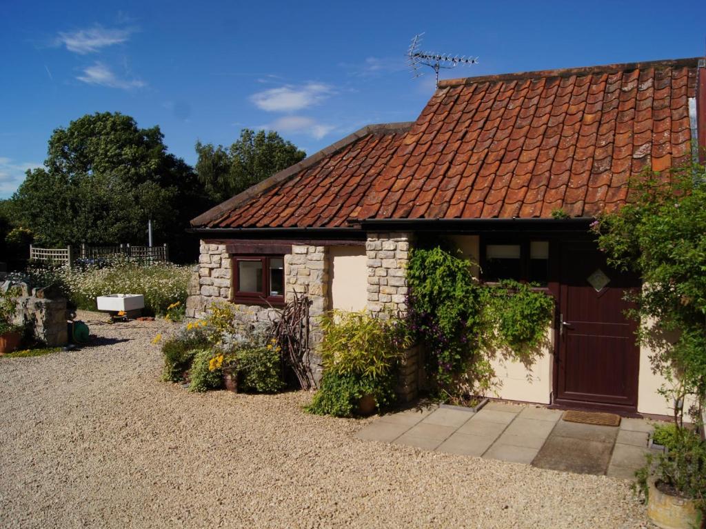 a cottage with a red roof and a driveway at 1 bed in Wedmore 51338 in Chapel Allerton