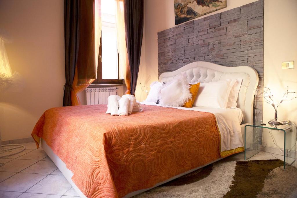 a bedroom with a bed with two cats laying on it at Luxury Domus in Rome