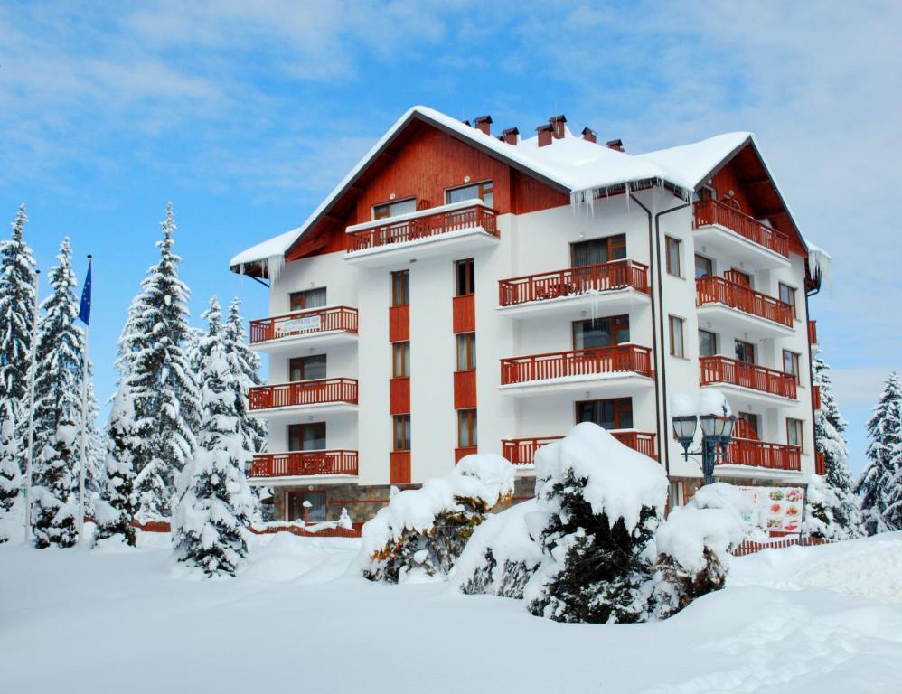 a hotel in the snow with snow covered trees at Luxury one bedroom apartment 402 in RILA PARK in Borovets