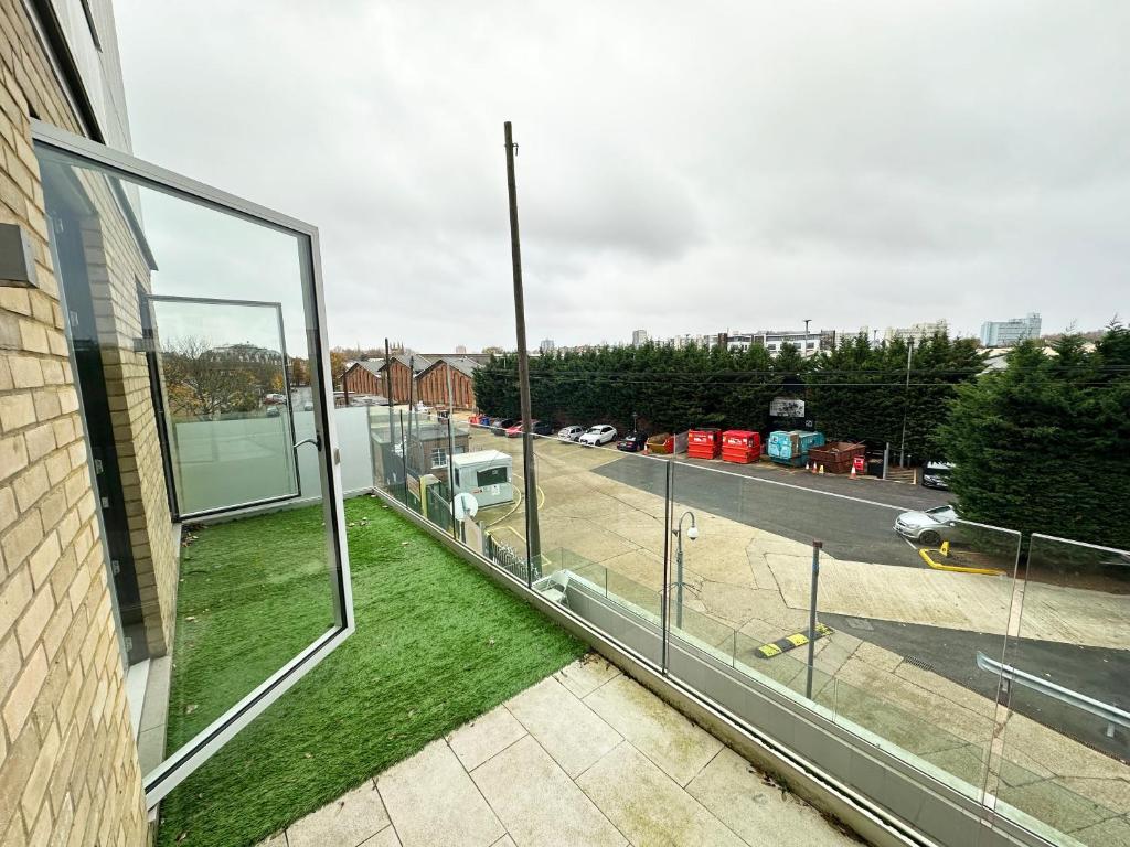 a glass balcony with a view of a street at Two bed in Clapham in London