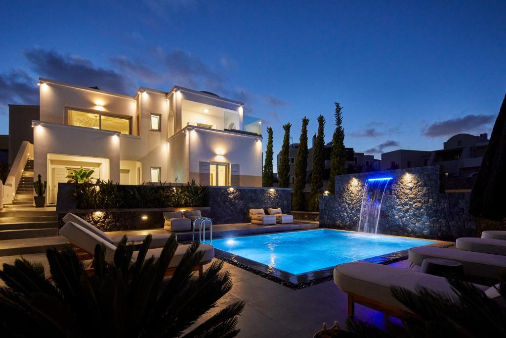 a villa with a swimming pool at night at EPICENTER LUXURY RESIDENCE in Mesaria