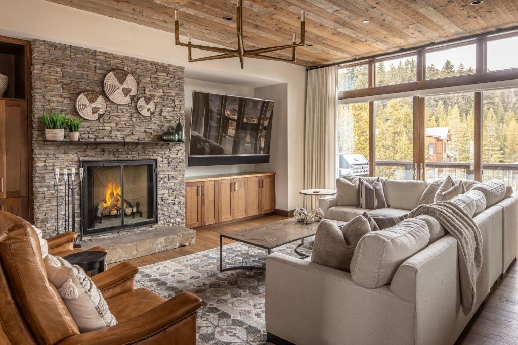 a living room with a couch and a fireplace at Spanish Peaks | Highlands Cabin 30 in Big Sky