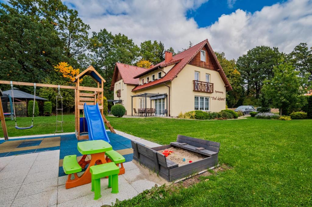 a backyard with a playground with a play equipment at Willa Pod Dębami in Kudowa-Zdrój