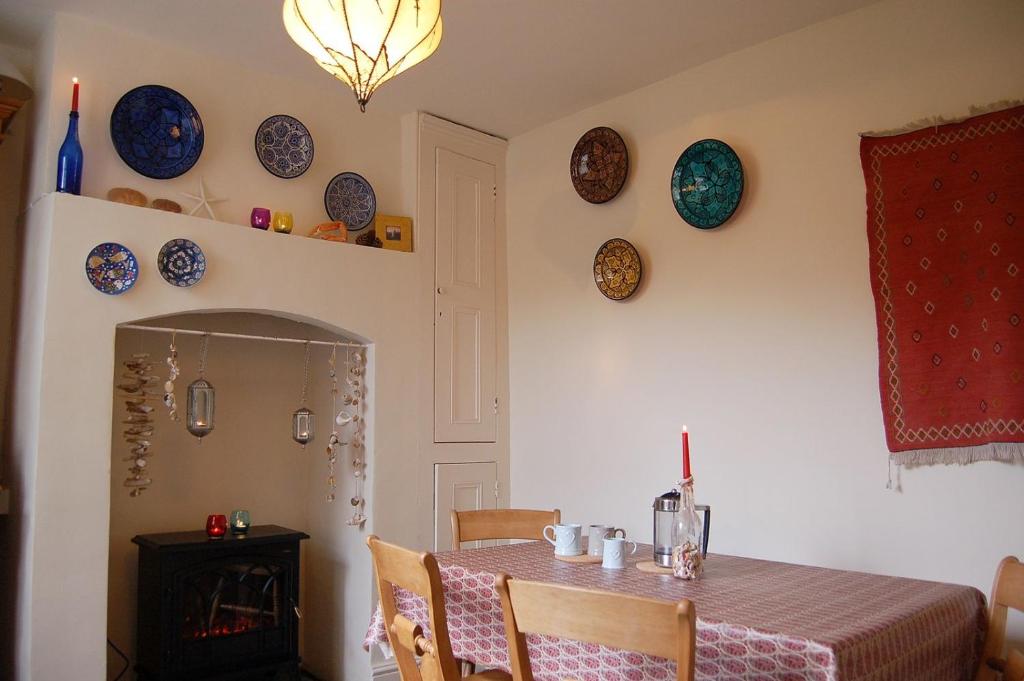 a dining room with a table and plates on the wall at Cadair View Family Holiday Home in Tywyn