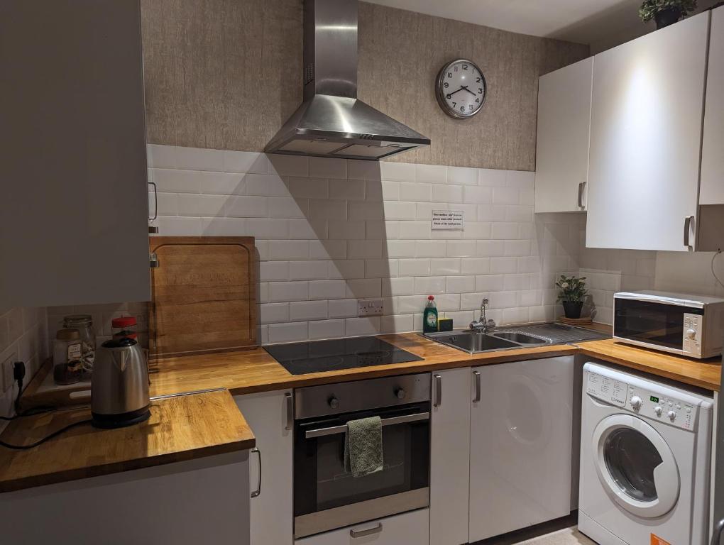 a kitchen with a sink and a stove top oven at Hostel Rooms In Camden in London