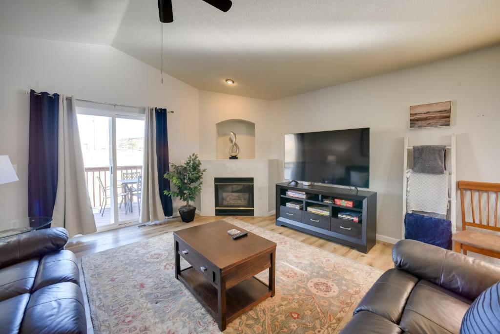 a living room with a couch and a flat screen tv at Updated Springs Home - 3 Mi to Garden of the Gods! in Colorado Springs