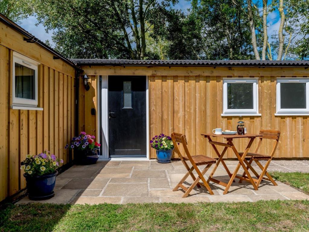 a patio with a table and chairs in front of a house at 1 Bed in Weymouth 78865 in Weymouth