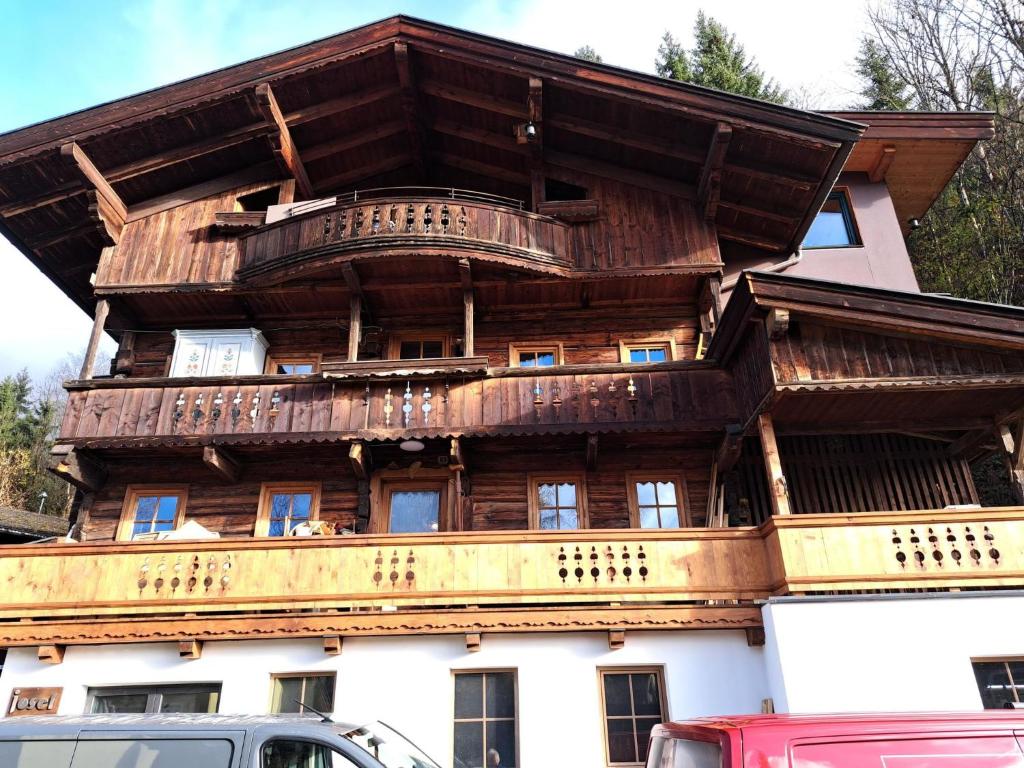 a wooden building with balconies on top of it at Apartment Mühltalschmiede by Interhome in Dorf