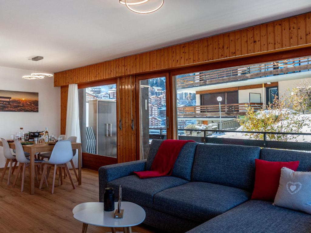 a living room with a couch and a table at Apartment Aiglon J2 by Interhome in Nendaz